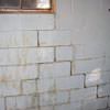 A cracked foundation wall near a window in a Fairfax Station home