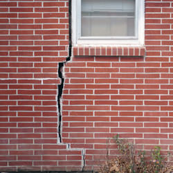 A foundation with a large crack that's wider at the top than on the bottom in Aldie