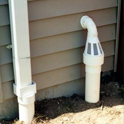 A grated sump pump discharge line fitting in Fairfax