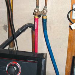 Washer hoses in a basement  in Purcellville